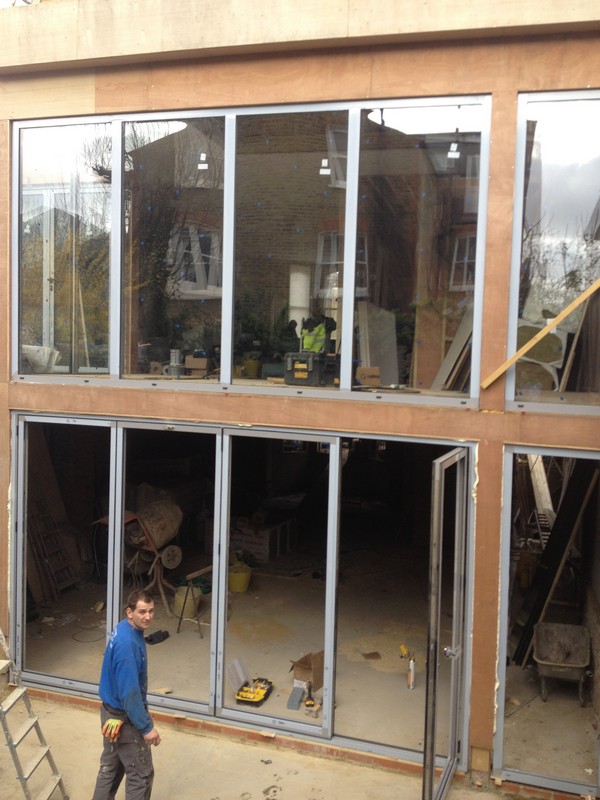 Aluminium bi-fold doors with two-storey glazing in Pinner