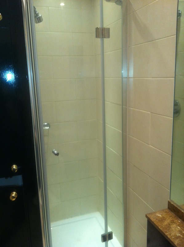 Frameless glass shower enclosure with chrome fittings in Pinner
