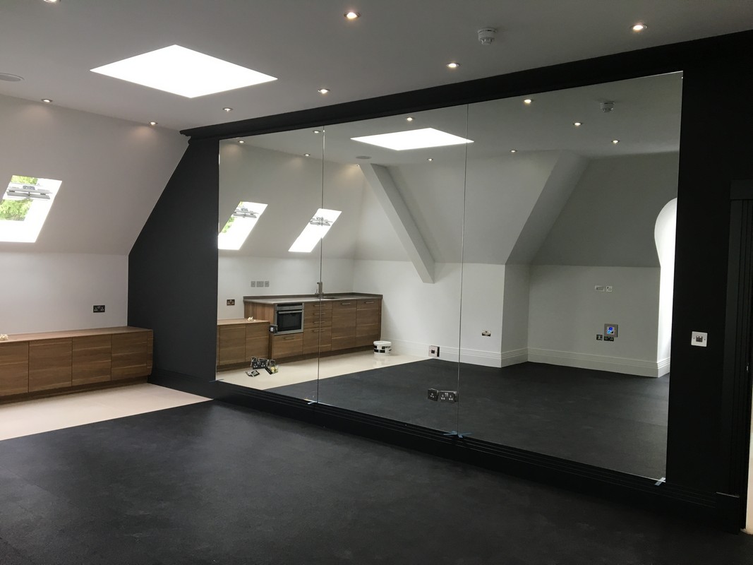 Frameless glass wall dividing loft conversion in Pinner