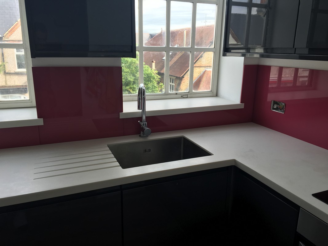 Deep plum coloured glass splashback in modern Pinner kitchen